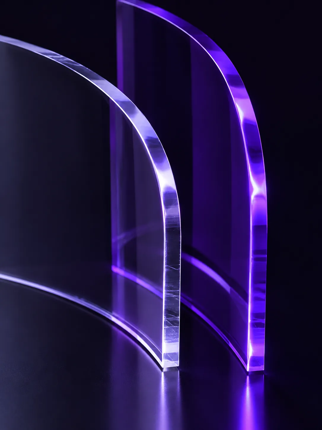 Curved plates of clear and violet cast acrylic
